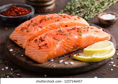 Fresh salmon fish fillet on wooden board - Shutterstock ID 1237146457