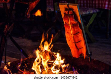 Fresh Salmon Grilled At An Open Fire Place