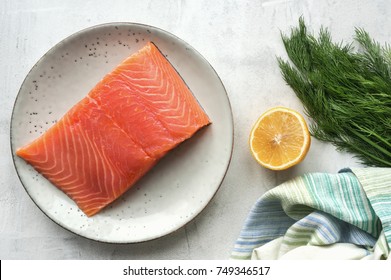 Fresh Salmon Steak, Lemon, Black Peppercorn And Dill On Concrete Table. Top View. Scandinavian Ingredients For Cooking. Overhead View. 