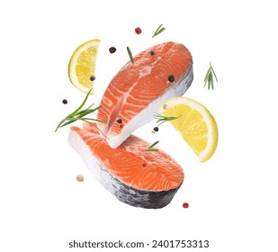 Fresh salmon steaks, spices and lemon slices falling on white background - Powered by Shutterstock