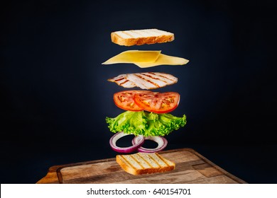 Fresh Sandwich With Flying Ingredients Isolated On Black Background. Copyspace For Text, High Resolution Image.