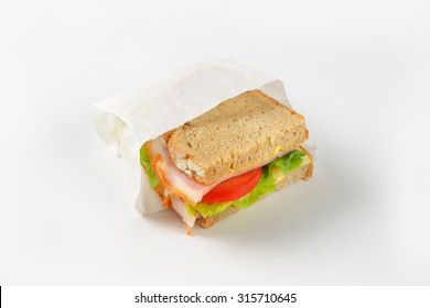 Fresh Sandwich With Ham, Cheese And Vegetables In Paper Bag