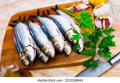 Fresh Sardine, Lemon And Garlic On A Kitchen Board In Cafe