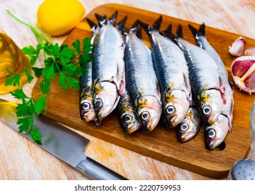 Fresh Sardine, Lemon And Garlic On A Kitchen Board In Cafe