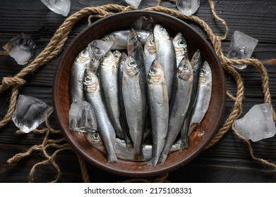 Fresh sardines on rustic wooden background. - Powered by Shutterstock