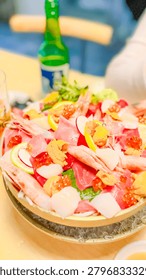 Fresh sashimi platter featuring assorted raw fish shrimp and uni served on a cold bed of ice for dinner dining
