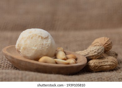 Fresh Scoop Of Peanut Butter Ice Cream With Peanuts In Wooden Bowls