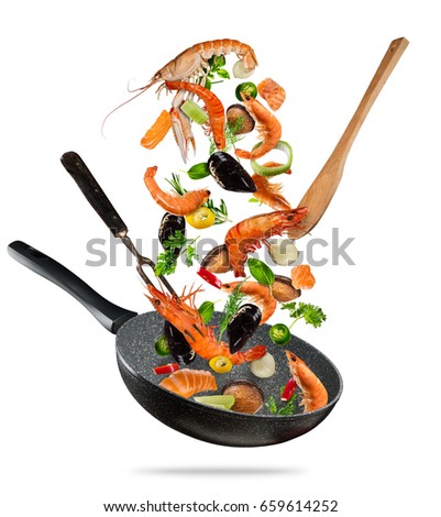 Fresh sea food vegetables flying into a pan, isolated on white background. Food preparation, fresh meal ready for cooking. Extra high resolution