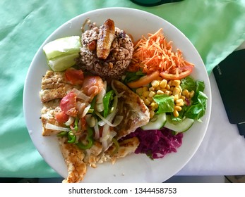 Fresh Seafood On A Plate In Belize.  Very Colorful Food On A White Plate.