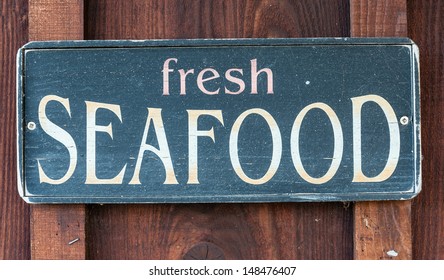 Fresh Seafood Restaurant Sign On Wooden Wall