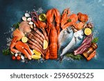 Fresh seafood. Wide food banner. Fish, octopus, lobster and other seafood on a gray stone table.