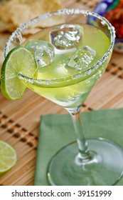 Fresh Sharp And Tangy Margarita On The Rocks With Salt And Lime - Shallow DOF On The Lime And Front Rim Of The Glass