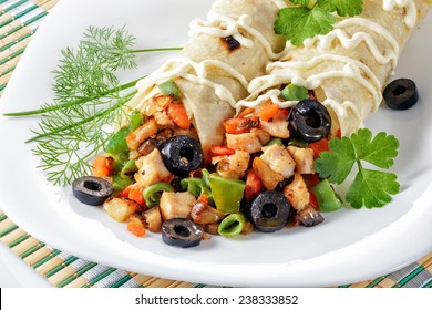 Fresh shawarma with chicken and vegetables on a white plate