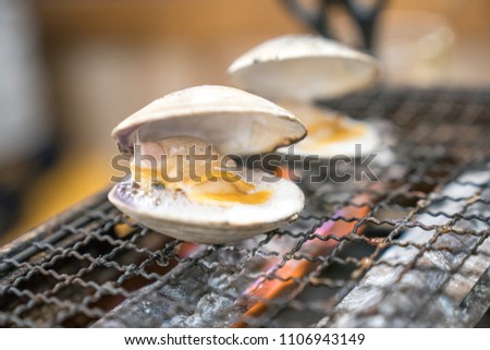 fresh shells are grilled on mini strove, in local Japanese restaurant.