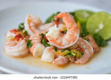 Fresh shrimp on white plate and fresh vegetables, cooked shrimps prawns and seafood spicy chili sauce coriander, cooking shrimp salad lemon lime - Shutterstock ID 2226997385