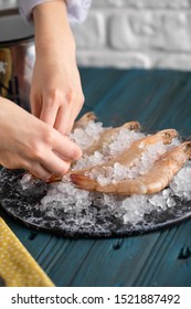 Fresh shrimps or prawns raw on  board with ice - Shutterstock ID 1521887492