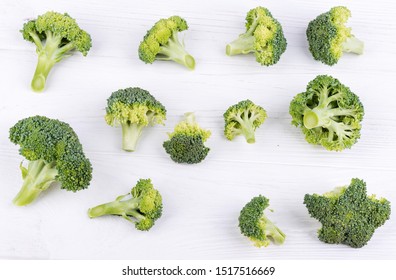 fresh sliced broccoli lies on a white wooden surface top view