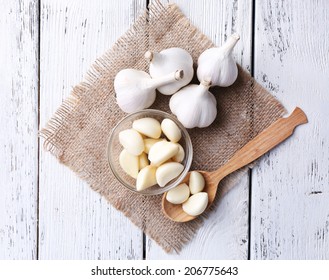 Fresh sliced garlic in glass bowl on wooden background - Powered by Shutterstock