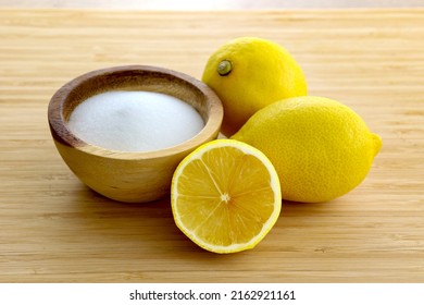 Fresh Sliced Lemon With Salt On Bamboo Table. Use For Safe Home Cleaning And DIY Household Nontoxic Cleaning Product Concept.