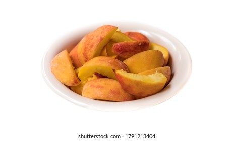 Fresh Sliced Peaches In A Bowl Isolated On A White Background. Delicious Fruit Commodity For Trade And Global Export