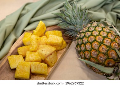 Fresh Sliced Pineapple On Wooden Tray On Table.