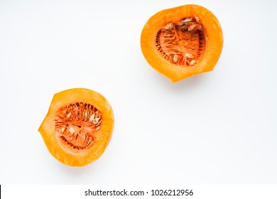 Fresh sliced pumpkin(squash) isolated on white background. Top view. Space for a text. Flat lay. Close up.
