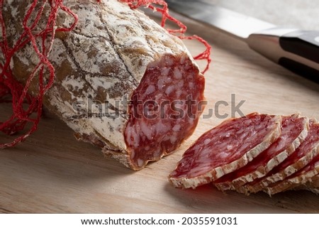 Fresh sliced Rosette de Lyon, a French pork saucisson close up