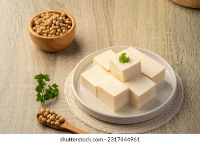 Fresh Sliced Soft Tofu soy bean curd on white plate.