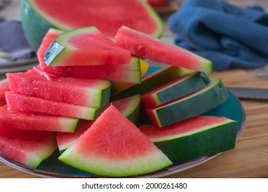 fresh sliced watermelon stacked on a plate