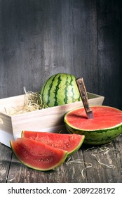 Fresh sliced watermelon wooden background, Ripe striped watermelon, Close-up of fresh slices of red watermelon, sweet harvest. 