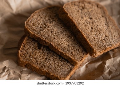 Fresh slices of bread lies on kraft paper