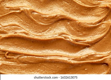 Fresh smooth Peanut Butter closeup background, texture