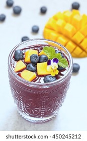 Fresh Smoothie With Mango And Blueberry Topping