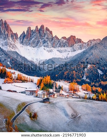 Fresh snow covered green hills on Santa Magdalena village. Fantastic autumn view of Seceda peak. Incredible landscape of Dolomite Alps, Italy. Traveling concept background.