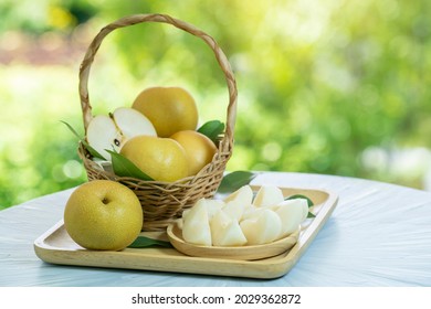 Fresh Snow Pear Fruit In Bamboo Basket On Blurred Greenery Background, Fresh Japanese Kumamoto Pear Fruit In The Basket On Natural Farm.