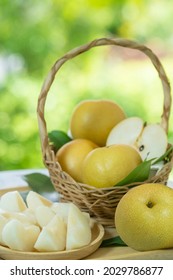 Fresh Snow Pear Fruit In Bamboo Basket On Blurred Greenery Background, Fresh Pear Fruit In The Basket On Natural Farm.