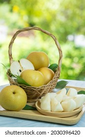 Fresh Snow Pear Fruit In Bamboo Basket On Blurred Greenery Background, Fresh Japanese Kumamoto Pear Fruit In The Basket On Natural Farm.