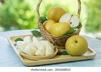 Fresh Snow Pear Fruit In Bamboo Basket On Blurred Greenery Background, Fresh Pear Fruit In The Basket On Natural Farm.