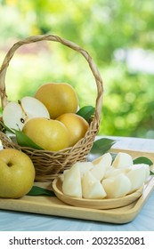 Fresh Snow Pear Fruit In Bamboo Basket On Blurred Greenery Background, Fresh Pear Fruit In The Basket On Natural Farm.