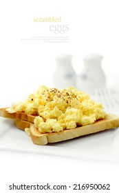 Fresh Soft, Fluffy Scrambled Eggs On Wholegrain Wheat Toast Against A White Background. Copy Space.