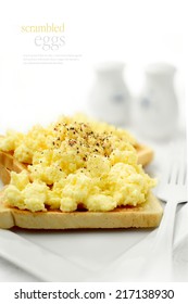 Fresh Soft, Fluffy Scrambled Eggs On Wholegrain Wheat Toast Against A White Background. Copy Space.