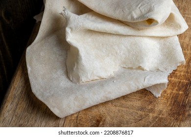 Fresh and soft wheat lavash on a board, Armenian lavash is stacked on a board during cooking - Shutterstock ID 2208876817