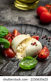 fresh soft white burrata cheese ball made from mozzarella and cream from Apulia, Italian Mediterranean cuisine, vertical image. top view. place for text.