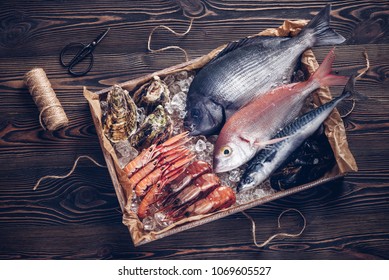 Fresh Spanish Fish And Seafood In Wooden Box On Wooden Table