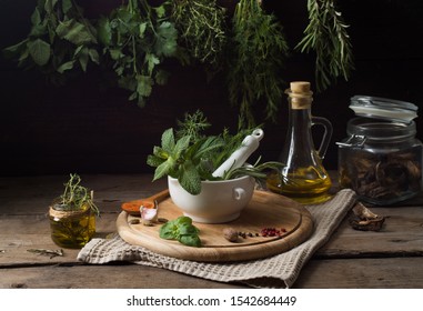 Fresh spices thyme, turmeric, cardamom, basil, mint, parsley, dill  and rosemary on wooden background.