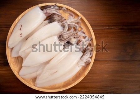 Fresh Splendid Squid on wooden plate, Fresh Squid in wooden plate on wooden background, 