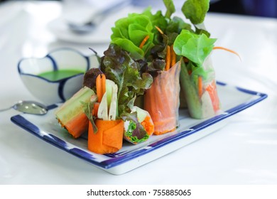 Fresh spring rolls or salad rolls made with fresh vegetable, crab stick and Vietnamese rice paper, serve with spicy salad cream dipping on glass plate