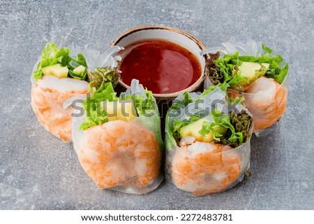 Fresh spring rolls with shrimp in rice paper. Rice paper rolls with shrimp, rice noodles, mango, lettuce and sauce.