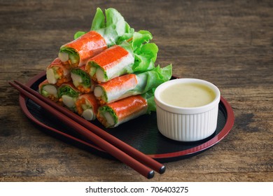 Fresh spring rolls with fresh vegetable and crab stick served with wasabi mixed salad cream dipping sauce. Rolls salad or fresh spring roll in Japanese style, healthy tasty food for appetizer or meal.