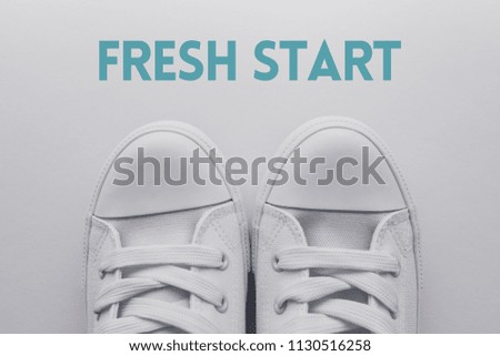 Fresh start and new beginning concept, youth style sneakers standing over title